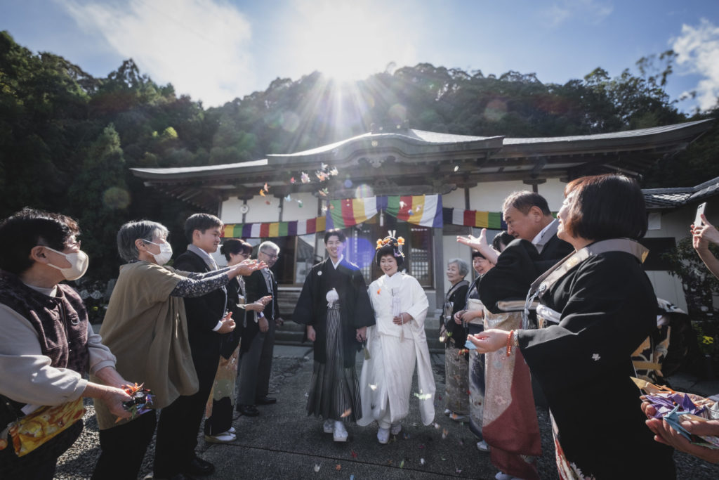 龍昇山江音寺本堂前にて折鶴シャワーで祝福される新郎新婦様